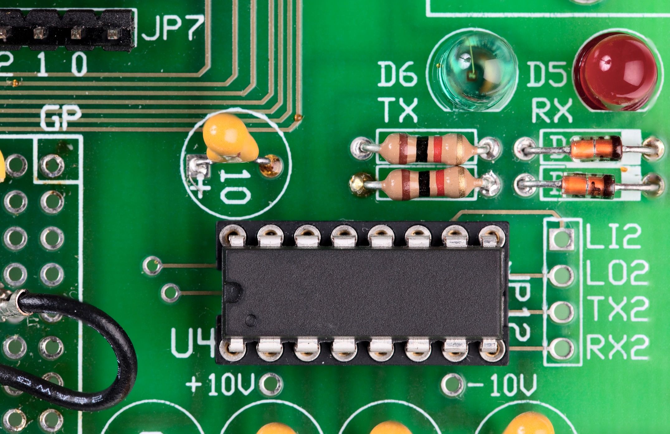 Close-up of an electronic circuit board used in arcade equipment